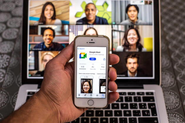 April 20, 2021, Barcelona, Catalonia, Spain: In this photo illustration, the Google Meet app in App Store seen displayed on a smartphone screen and a Google Meet Desktop on a laptop in the background. Barcelona Spain - ZUMAd159 20210420_zia_d159_096 Copyright: xThiagoxPrudenciox