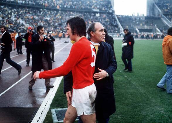 Football - 1972 UEFA European Football Championship Qualifying - Quarter Final Second Leg: West Germany 0 England 0 England manager Alf Ramsey consoles Roy McFarland as he leaves the field at the end of the game in the Olympiastadion, West Berlin. Germany won the tie by an aggregate score of 3-1.