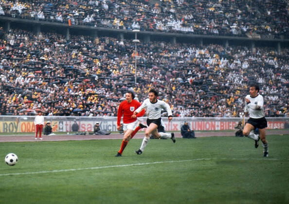 Football - 1972 UEFA European Football Championship Qualifying - Quarter Final Second Leg: West Germany 0 England 0 England s Mike Summerbee and West Germany s Heinz Flohe and Horst-Dieter Hottges chase the ball in the Olympiastadion, West Berlin. Germany won the tie by an aggregate score of 3-1.