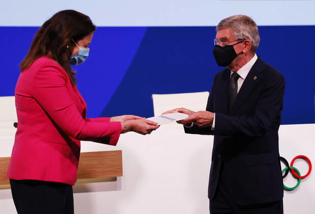(210721) -- TOKYO, July 21, 2021 -- International Olympic Committee Thomas Bach (R) presents the Honourable Annastacia Palaszczuk MP, Premier of Queensland and Minister for Trade, with a card after Brisbane was announced as the 2032 Summer Olympics host city during the 138th International Olympic Committee (IOC) Session in Tokyo, Japan, on July 21, 2021. ( Pool via Xinhua) (SP)TOKYO-JAPAN-IOC-138TH SESSION ToruxHanai 