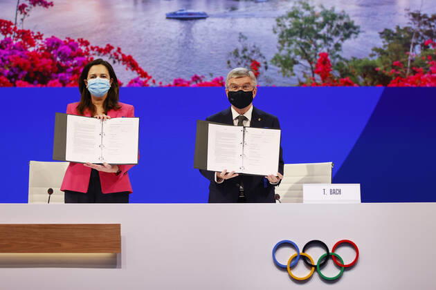 (210721) -- TOKYO, July 21, 2021 -- The Honourable Annastacia Palaszczuk MP, Premier of Queensland and Minister for Trade (L), and President of the International Olympic Committee Thomas Bach hold up copies of the Host Agreement after Brisbane was announced as the 2032 Summer Olympics host city during the 138th International Olympic Committee (IOC) Session in Tokyo, Japan, on July 21, 2021. ( Pool via Xinhua) (SP)TOKYO-JAPAN-IOC-138TH SESSION ToruxHanai 