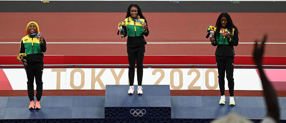 (210801) -- TOKYO, Aug. 1, 2021 -- Gold medalist Elaine Thompson-Herah (C), silver medalist Shelly-Ann Fraser-Pryce (L) and bronze medalist Shericka Jackson of Jamaica react during the awarding ceremony of the Women s 100m at the Tokyo 2020 Olympic Games, Olympische Spiele, Olympia, OS in Tokyo, Japan, Aug. 1, 2021. ) (TOKYO2020)JAPAN-TOKYO-OLY-ATHLETICS-WOMEN S 100M-AWARDING CEREMONY LixYibo 