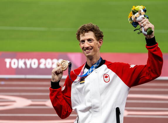 August 7, 2021, Tokyo, Japan: Evan Dunfee of Canada shows off his bronze medal for the menÃ¢â‚¬â ¢s 50km race walk at the Tokyo Olympics in Tokyo, Japan on Saturday August 7, 2021. Canada News - August 7, 2021  - ZUMAc35_ 20210807_zaf_c35_032 Copyright: xFrankxGunnx