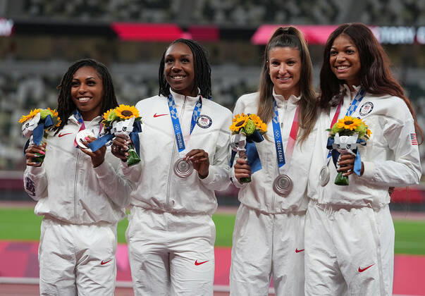 (210807) -- TOKYO, Aug. 7, 2021 -- Team members of the United States react during the awarding ceremony of the Women s 4x100m Relay at the Tokyo 2020 Olympic Games, Olympische Spiele, Olympia, OS in Tokyo, Japan, Aug. 7, 2021. ) (TOKYO2020)JAPAN-TOKYO-OLY-ATHLETICS-WOMEN S 4x100M RELAY-AWARDING CEREMONY LuixSiuxWai 
