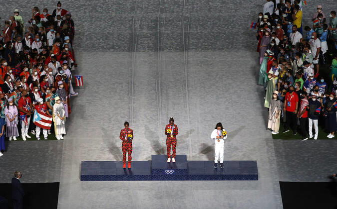 TOKYO, JAPAN - AUGUST 8, 2021: Silver medallist Brigid Kosgei of Kenya, gold medal winner Peres Jepchirchir of Kenya and bronze medallist Molly Seidel of the United States (L-R centre) attend the victory ceremony for the ladies marathon final during the closing ceremony of the 2020 Summer Olympic Games, Olympische Spiele, Olympia, OS at the Japan National Stadium (a.k.a the Olympic Stadium). The Olympic Games were held amid the COVID-19 pandemic. The closing ceremony features live and pre-recorded elements. Sergei Bobylev TASS  TS10C10C