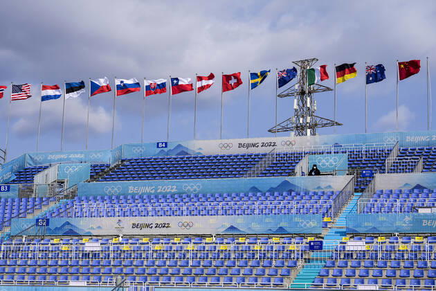 A lone security guard stands amongst empty seating at the Big Air Shougang venue which will host the big air events at the Beijing 2022 Winter Olympics on Monday, January 31, 2022.  OLY20220131299 PaulxHanna