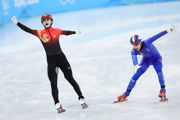 (220205) -- BEIJING, Feb. 5, 2022 -- Wu Dajing (L) of China celebrates after crossing the finishing line during the mixed team relay final of short track Speed skating, Eisschnelllauf at Capital Indoor Stadium in Beijing, China, Feb. 5, 2022. ) (BEIJING 2022)CHINA-BEIJING-OLYMPIC Winter games, Winterspiele,Spiele, Summer games SHORT TRACK SPEED SKATING (CN) LanxHongguang 