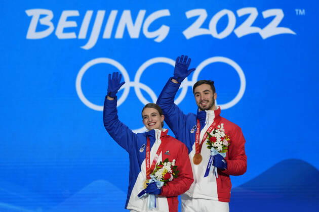 Gold medallists Gabriella Papadakis and Guillaume Cizeron of France wave with their medals during the medal ceremony for the Figure skating, Eiskunstlauf Ice Dance competition at the Beijing 2022 Winter Olympics on Monday, February 14, 2022.  OLY20220214318 PaulxHanna