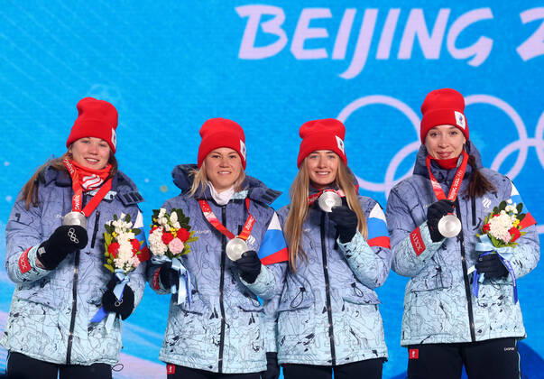 ZHANGJIAKOU, CHINA - FEBRUARY 17, 2022: Silver medallists Irina Kazakevich, Kristina Reztsova, Svetlana Mironova and Ulyana Nigmatullina of Team ROC (L-R) celebrate during the victory ceremony for the women s biathlon 4x7.5km relay, at the Medal Plaza, at the 2022 Winter Olympic Games, Olympische Spiele, Olympia, OS Stanislav Krasilnikov TASS  TS123D16