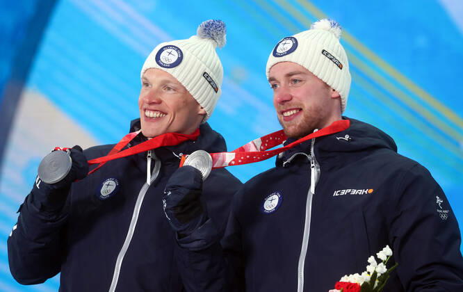 ZHANGJIAKOU, CHINA - FEBRUARY 17, 2022: Silver medallists Iivo Niskanen (L) and Joni Maki of Finland celebrate during the victory ceremony for the men s cross-country skiing team sprint classic, at the Medal Plaza, at the 2022 Winter Olympic Games, Olympische Spiele, Olympia, OS Stanislav Krasilnikov TASS  TS123D56