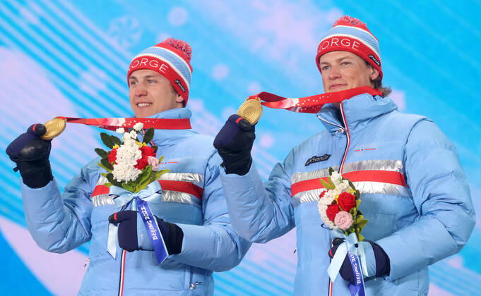 ZHANGJIAKOU, CHINA - FEBRUARY 17, 2022: Gold medal winners Erik Valnes and Johannes Hoesflot Klaebo of Norway celebrate during the victory ceremony for the men s cross-country skiing team sprint classic, at the Medal Plaza, at the 2022 Winter Olympic Games, Olympische Spiele, Olympia, OS Stanislav Krasilnikov TASS  TS123D57