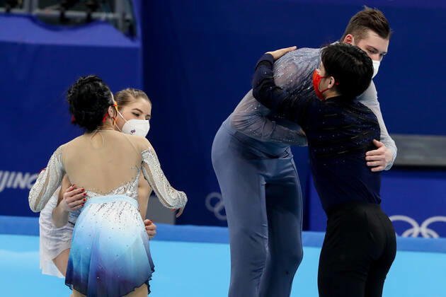BEIJING, CHINA - FEBRUARY 19, 2022: Silver medalists Yevgenia Tarasova and Vladimir Morozov of Team ROC (back) and gold medalists Jin Yang and Peng Cheng of China (front) hug at a flower ceremony for the pair skating at the 2022 Winter Olympic Games, Olympische Spiele, Olympia, OS at the Capital Indoor Stadium. Valery Sharifulin TASS  TS124592