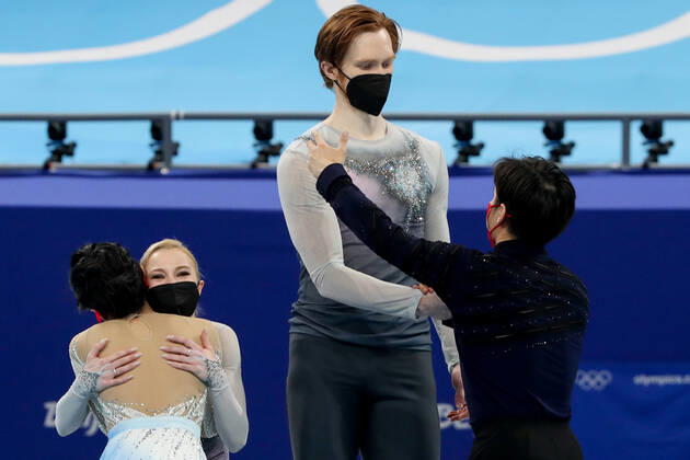 BEIJING, CHINA - FEBRUARY 19, 2022: Silver medalists Yevgenia Tarasova and Vladimir Morozov of Team ROC (back) and gold medalists Jin Yang and Peng Cheng of China (front) hug at a flower ceremony for the pair skating at the 2022 Winter Olympic Games, Olympische Spiele, Olympia, OS at the Capital Indoor Stadium. Valery Sharifulin TASS  TS124593