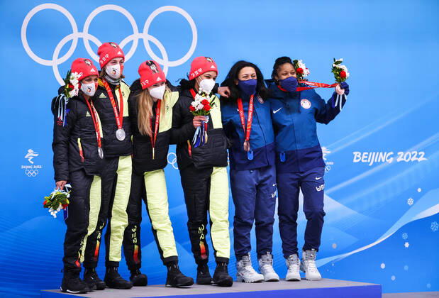 BEIJING, CHINA - FEBRUARY 19, 2022: Silver medalists Mariama Jamanka and Alexandra Burghardt of Germany, gold medalists Laura Nolte and Deborah Levi of Germany, bronze medalists Elana Meyers Taylor and Sylvia Hoffman of the USA (L-R) at a flower ceremony for the 2-woman bobsleigh at the 2022 Winter Olympic Games, Olympische Spiele, Olympia, OS at the Yanqing National Sliding Centre. Anton Novoderezhkin TASS  TS124673