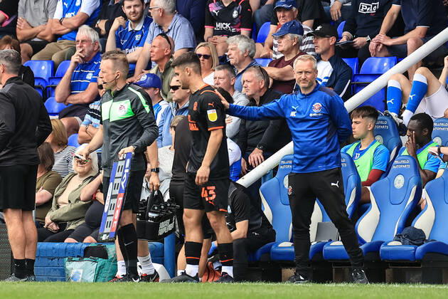 Sky Bet Championship Peterborough v Blackpool Neil Critchley head coach of Blackpool pats Jake Daniels 43 of Blackpool on the back as he prepares to make his club debut Peterborough Weston Homes Stadium Cambridgeshire United Kingdom Copyright: xMarkxCosgrove NewsxImagesx