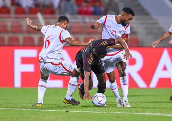 FUSSBALL WM 2022 Testspiel im Oman 16.11.2022 Oman - Deutschland: Youssoufa Moukoko (Mitte, Deutschland) gegen AHMED AL-KHAMISI (li) und HARIB ALSAADI (re, beide Omar)