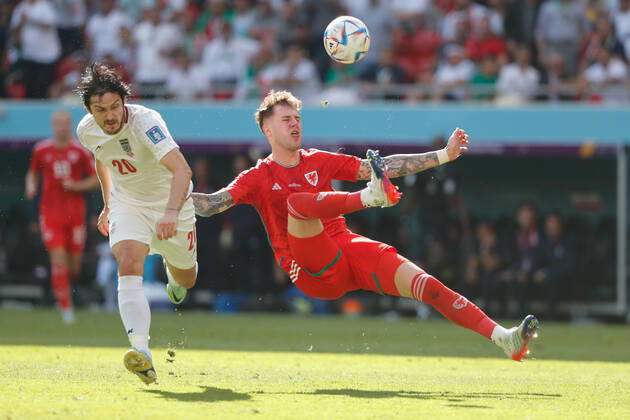 Wales v Iran 2022 FIFA World Cup, WM, Weltmeisterschaft, Fussball Joe Rodon of Wales clashes with Sardar Azmoun of Iran during the 2022 FIFA World Cup Group B match at Ahmad Bin Ali Stadium, Al-Rayyan Content Not Available For UK Newspapers Copyright: xPaulxChestertonx FIL-17643-0064 UK Newspapers OUT