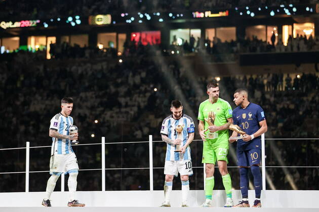 QATAR, LUSAIL - DECEMBER 18, 2022: Argentina s player Enzo Fernandez, captain Lionel Messi and goalkeeper Emiliano Martinez and France captain Kylian Mbappe (L-R) are seen during the trophy ceremony for the 2022 FIFA World Cup, WM, Weltmeisterschaft, Fussball final football match between Argentina and France at Lusail Iconic Stadium. Argentina won 3-3 (4-2) in a penalty shootout. Sergei Bobylev TASS  56487354