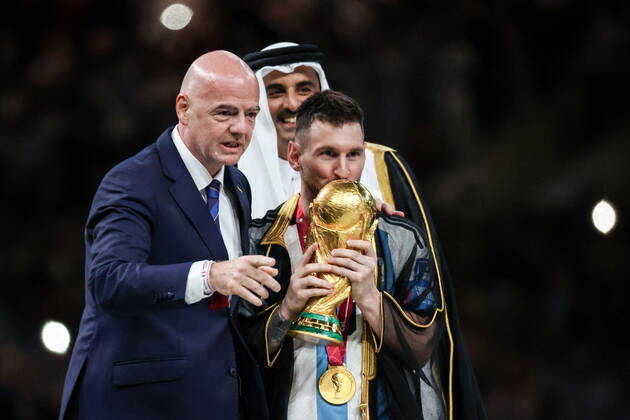 QATAR, LUSAIL - DECEMBER 18, 2022: FIFA president Gianni Infantino, Argentina captain Lionel Messi (L-R front) and Emir of Qatar Tamim bin Hamad Al Thani are seen during the trophy ceremony for the 2022 FIFA World Cup, WM, Weltmeisterschaft, Fussball final football match between Argentina and France at Lusail Iconic Stadium. Argentina won 3-3 (4-2) in a penalty shootout. Sergei Bobylev TASS  56487951