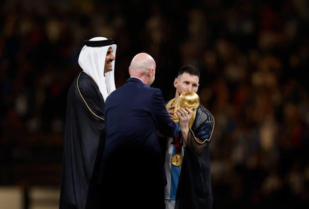 (221218) -- LUSAIL, Dec. 18, 2022 -- FIFA President Gianni Infantino (C) and The Emir of Qatar Sheikh Tamim bin Hamad Al Thani (L) award Lionel Messi of Argentina during the awarding ceremony of the 2022 FIFA World Cup, WM, Weltmeisterschaft, Fussball at Lusail Stadium in Lusail, Qatar, Dec. 18, 2022. ) (SP)QATAR-LUSAIL-2022 WORLD CUP-FINAL-ARG VS FRA WangxLili
