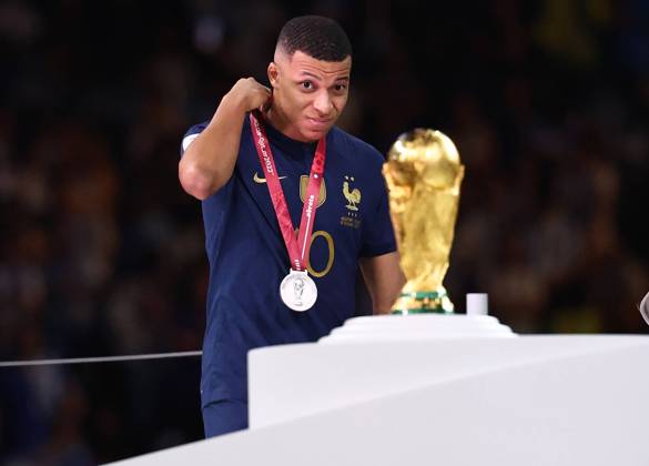 Doha, Qatar, 18th December 2022. Kylan Mbappe of France glance at the World Cup as he collects his looters medal during the FIFA World Cup, WM, Weltmeisterschaft, Fussball 2022 match at Lusail Stadium, Doha. Picture credit should read: David Klein Sportimage EDITORIAL USE ONLY. No use with unauthorised audio, video, data, fixture lists, club league logos or live services. Online in-match use limited to 120 images, no video emulation. No use in betting, games or single club league player publications. SPI-2101-0214
