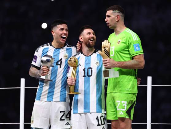 Doha, Qatar, 18th December 2022. Enzo Fernandez of Argentina Young player of the Tournament, Lionel Messi of Argentina player of the Tournament and Golden Glove winner Emiliano Martinez of Argentina during the FIFA World Cup, WM, Weltmeisterschaft, Fussball 2022 match at Lusail Stadium, Doha. Picture credit should read: David Klein Sportimage EDITORIAL USE ONLY. No use with unauthorised audio, video, data, fixture lists, club league logos or live services. Online in-match use limited to 120 images, no video emulation. No use in betting, games or single club league player publications. SPI-2101-0215