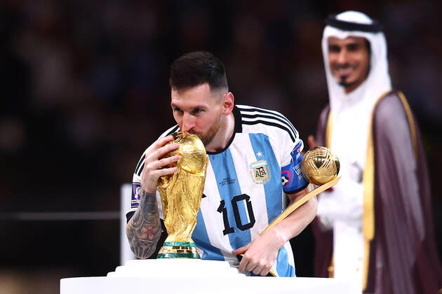 Lionel Messi of Argentina kisses the FIFA World Cup, WM, Weltmeisterschaft, Fussball trophy following the 2022 FIFA World Cup Final at Lusail Stadium in Lusail City, Qatar on December 18, 2022. LUS20221218111 CHRISxBRUNSKILL