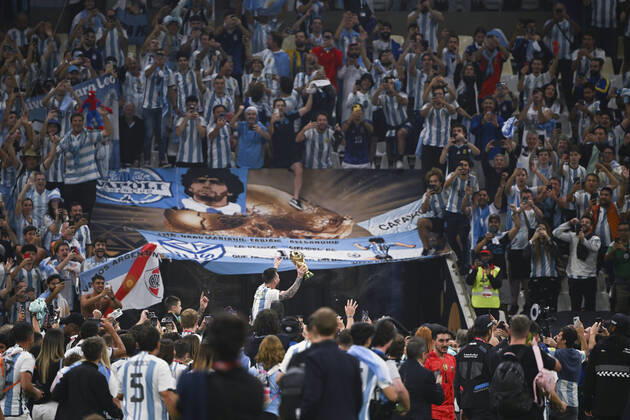 (221218) -- LUSAIER, Dec. 18, 2022 -- Lionel Messi of Argentina celebrates with the trophy in front of the fans after winning the Final between Argentina and France at the 2022 FIFA World Cup, WM, Weltmeisterschaft, Fussball at Lusail Stadium in Lusail, Qatar, Dec. 18, 2022. ) (SP)QATAR-LUSAIL-2022 WORLD CUP-FINAL-ARG VS FRA LixGa