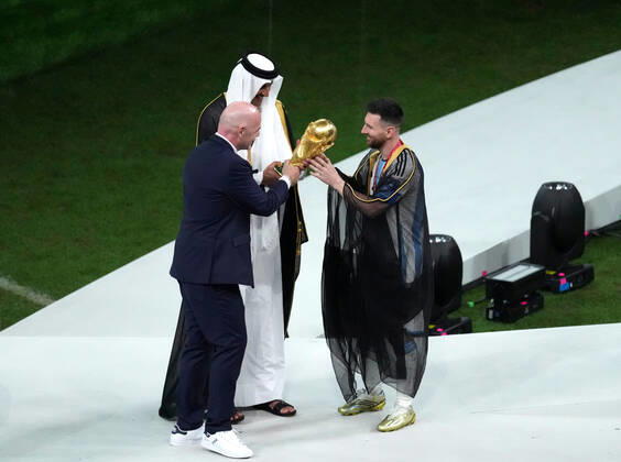 (221219) -- LUSAIL, Dec. 18, 2022 -- FIFA President Gianni Infantino (L) and the Emir of Qatar Sheikh Tamim bin Hamad Al Thani (C) award Lionel Messi of Argentina during the 2022 FIFA World Cup, WM, Weltmeisterschaft, Fussball at Lusail Stadium in Lusail, Qatar, Dec. 18, 2022. ) (SP)QATAR-LUSAIL-2022 WORLD CUP-FINAL-ARG VS FRA PanxYulong