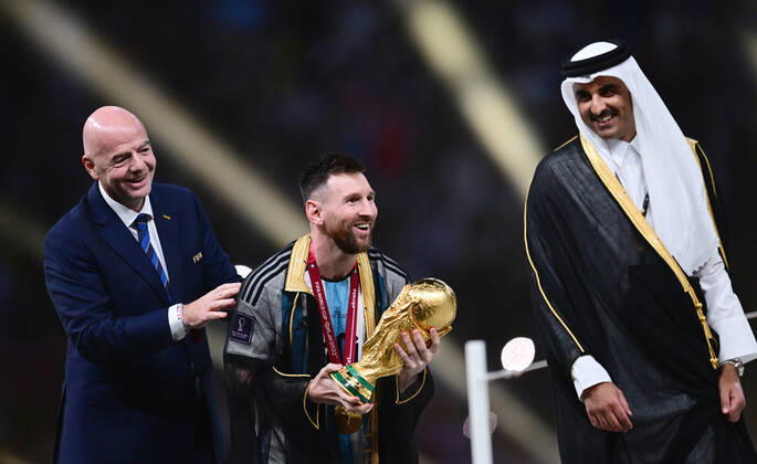 FUSSBALL WM 2022 Finale Argentinien - Frankreich 18.12.2022 Siegerehrung, JUBEL Weltmeister Argentinien; FIFA Praesident Gianni Infantino (li, Schweiz) und der Emir von Katar, Scheich Tamir bin Hamad bin Khalifa al Thani (re) mit Lionel Messi mit WM Pokal