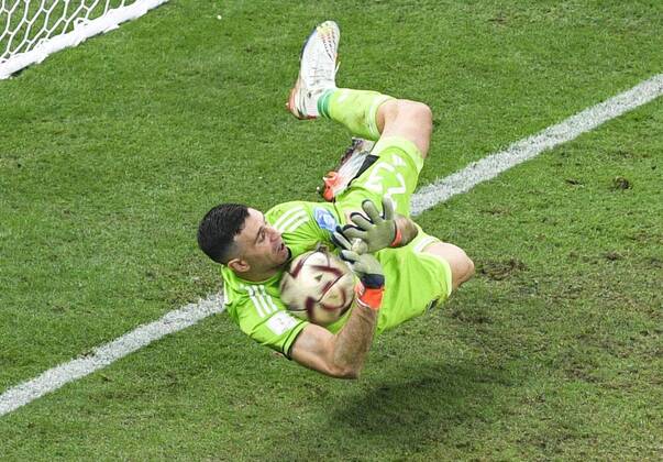Football World Cup in Qatar Argentina goalkeeper Emiliano Martinez saves a shot from France s Kingsley Coman during a penalty shootout in the World Cup football final at Lusail Stadium in Lusail, Qatar, on Dec. 18, 2022.  A14AA0001377695P 