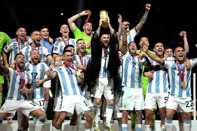 LUSAIL CITY, QATAR - DECEMBER 18: Lionel Messi of Argentina lifts the FIFA World Cup, WM, Weltmeisterschaft, Fussball Trophy after winning the FIFA World Cup Qatar 2022 Final match between Argentina and France at Lusail Stadium on December 18, 2022 in Lusail City, Qatar. WCS 