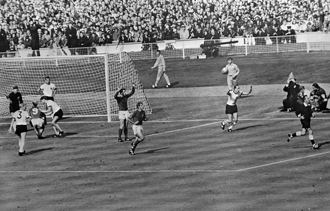 Controversial third goal. Wembley, England : Swiss referee, Gottfried Dienst (right ) runs out to consult the Russian linesman as England s Bobby Charlton ( no. 9 ) tries to demonstrate to the German players that Geoff Hurst s shot was a goal. Hurst ( arms raised ) watches anxiously while team mate , Roger Hunt , runs after the referee . The ball hit the crossbar and rebounded down . All the England players claimed the ball had crossed the line to register England s third goal . After consulting the linesman the referee allowed the goal . 30 July 1966 United Kingdom England  Copyright: xTopFotox 1391569