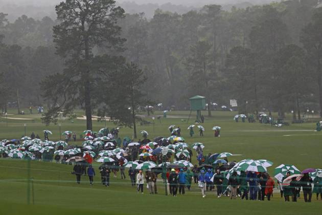 Golf: Masters Tournament Spectators leave the grounds after play was suspended for the day due to bad weather during the third round of the Masters Tournament at Augusta National Golf Club in Augusta, Georgia, on April 8, 2023.  A14AA0001414708P 