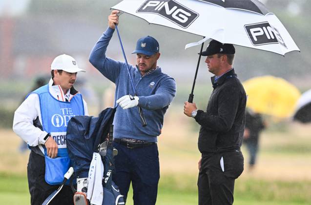 Mandatory Credit: Photo by Greig Cowie Shutterstock (14012011da) Bryson DeChambeau on the 16th fairway shelters from the rain The British Open Championship, Practice, Golf, Royal Liverpool Golf Club, Liverpool, UK - 17 Jul 2023 The British Open Championship, Practice, Golf, Royal Liverpool Golf Club, Liverpool, UK - 17 Jul 2023  Copyright: xGreigxCowie Shutterstockx 14012011da