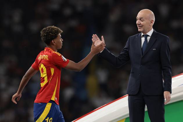 Berlin, Germany, 14th July 2024. Lamine Yamal of Spain shakes hands with Bernd Neuendorf, President of the German Football Association (DFB) as he makes his way forward to collect the Young Player of the Tournament award from UEFA President Aleksander Ceferin following the UEFA European Championships final match at Olympiastadion, Berlin. Picture: Jonathan Moscrop Sportimage EDITORIAL USE ONLY. No use with unauthorised audio, video, data, fixture lists, club league logos or live services. Online in-match use limited to 120 images, no video emulation. No use in betting, games or single club league player publications. SPI-3226-0130