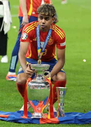 Berlin, Germany, 14th July 2024. Lamine Yamal of Spain poses with the Henri Delaunay Cup and his Young Player of the Tournament Award following the 2-1 victory in the UEFA European Championships final match at Olympiastadion, Berlin. Picture: Jonathan Moscrop Sportimage EDITORIAL USE ONLY. No use with unauthorised audio, video, data, fixture lists, club league logos or live services. Online in-match use limited to 120 images, no video emulation. No use in betting, games or single club league player publications. SPI-3226-0374