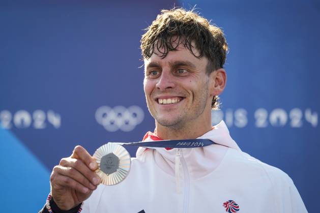 Adam Burgess of Team Great Britain smiles with his silver medal during the podium ceremony for the Men s C1 Canoe Slalom final at the Vaires-sur-Marne Nautical Stadium outside Paris during the 2024 Paris Summer Olympic Games, Olympische Spiele, Olympia, OS in Paris, France, Monday, July 29, 2024.  OLY20240729408 PaulxHanna
