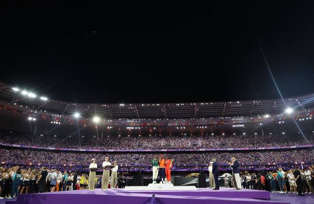 (240811) -- PARIS, Aug. 11, 2024 -- Gold medalist Sifan Hassan (C) of the Netherlands, silver medalist Tigst Assefa (L) of Ethiopia and bronze medalist Hellen Obiri of Kenya pose for photos during the victory ceremony of women s marathon of Athletics at the closing ceremony of the Paris 2024 Olympic Games, Olympische Spiele, Olympia, OS at the Stade de France in Paris, France, Aug. 11, 2024. ) (PARIS2024) FRANCE-PARIS-OLY-CLOSING CEREMONY CaoxCan 