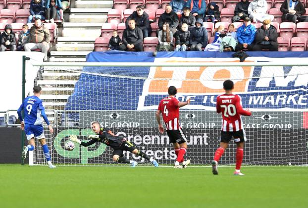 Wigan Athletic v Exeter City EFL Sky Bet League 1 28 09 2024. Exeter City goalkeeper Joe Whitworth (1) saves a shot from Wigan Athletic midfielder Dion Rankine (7) during the EFL Sky Bet League 1 match between Wigan Athletic and Exeter City at the Brick Community Stadium, Wigan, England on 28 September 2024. Wigan Brick Community Stadium Greater Manchester England Editorial use only DataCo restrictions apply See www.football-dataco.com , Copyright: xJohnxBradleyx PSI-20514-0015