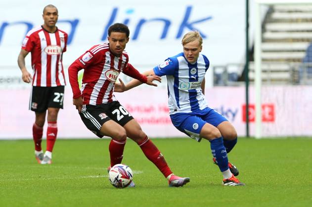 Wigan Athletic v Exeter City EFL Sky Bet League 1 28 09 2024. Exeter City midfielder Kamari Doyle (20) and Wigan Athletic midfielder Matt Smith (8) battle for possesion during the EFL Sky Bet League 1 match between Wigan Athletic and Exeter City at the Brick Community Stadium, Wigan, England on 28 September 2024. Wigan Brick Community Stadium Greater Manchester England Editorial use only DataCo restrictions apply See www.football-dataco.com , Copyright: xJohnxBradleyx PSI-20514-0018