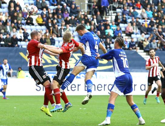 Wigan Athletic v Exeter City EFL Sky Bet League 1 28 09 2024. Wigan Athletic defender Will Aimson (4) heads at goal late on but sees his header saved during the EFL Sky Bet League 1 match between Wigan Athletic and Exeter City at the Brick Community Stadium, Wigan, England on 28 September 2024. Wigan Brick Community Stadium Greater Manchester England Editorial use only DataCo restrictions apply See www.football-dataco.com , Copyright: xJohnxBradleyx PSI-20514-0023