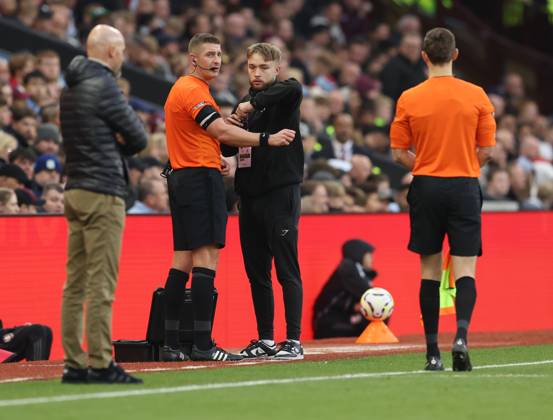 Football - 2024 2025 Premier League - Aston Villa vs Manchester United, ManU - Villa Park - Sunday 6th October 2024 Referee Robert Jones is assisted after his equipment failed