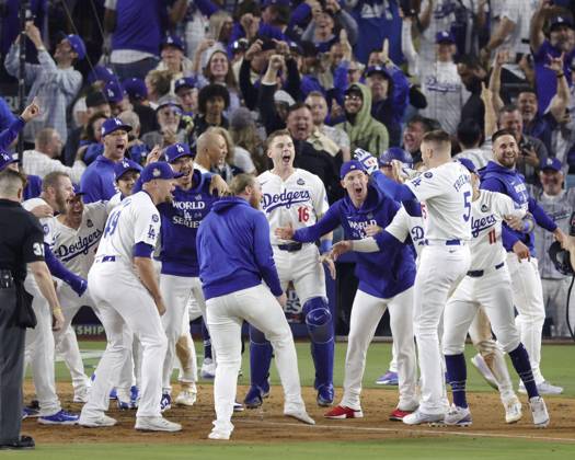 Baseball: World Series Freddie Freeman (5) of the Los Angeles Dodgers is congratulated by teammates after hitting a walk-off grand slam in the 10th inning of Game 1 of the World Series against the New York Yankees at Dodger Stadium in Los Angeles on Oct. 25, 2024.  A14AA0003639776P