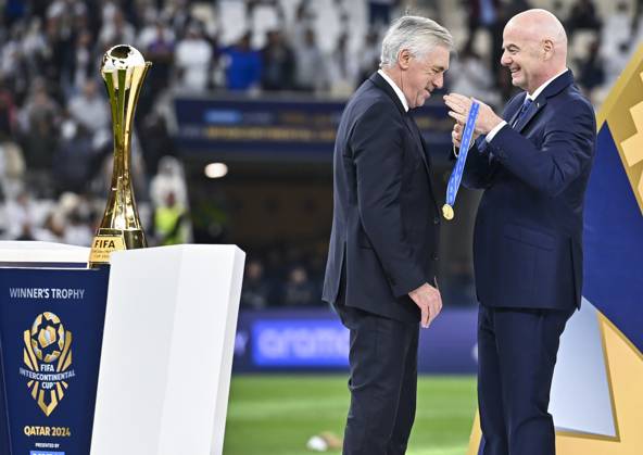 (241219) -- LUSAIL, Dec. 19, 2024 -- FIFA President Gianni Infantino (R) awards Carlo Ancelotti, head coach of Real Madrid, with the gold medal during the podium ceremony after the FIFA Intercontinental Cup Qatar 2024 Final match between Spain s Real Madrid and Mexico s CF Pachuca at Lusail Stadium in Lusail, Qatar, on Dec. 18, 2024. (Photo by Xinhua) (SP)QATAR-LUSAIL-FIFA INTERCONTINENTAL CUP-FINAL-REAL MADRID VS PACHUACA Nikku