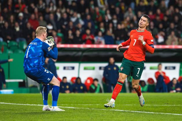 March 23, 2025, Lisbon, Portugal: Cristiano Ronaldo of Portugal (R) and goalkeeper Kasper Schmeichel of Denmark (L) in action during the UEFA Nations League Quarterfinal Leg Two match between Portugal and Denmark at Estadio Jose Alvalade. Lisbon Portugal - ZUMAs197 20250323_aaa_s197_535 Copyright: xHenriquexCasinhasx