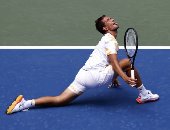 Vit Kopriva of Czechia reacts after stretching out to return a ball to Jannik Sinner of Italy in the first set of their first round match in Arthur Ashe Stadium on day 3 at the 2025 US Open Tennis Championship at the USTA Billie Jean King National Tennis Center in New York City on Tuesday, August 26, 2025.  NYP20250826128 JOHNxANGELILLO