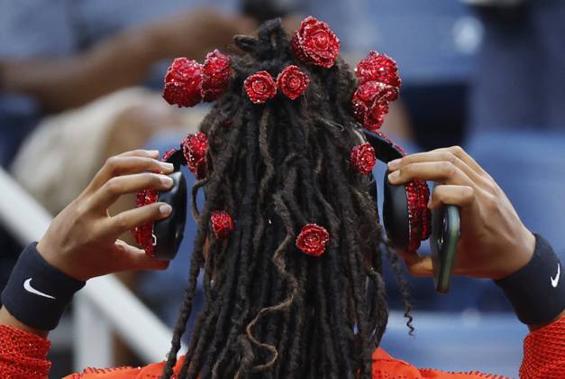 Naomi Osaka of Japan removes her headphones before she warms up on the court in her first round match against Greet Minnen of Belgium in Louis Armstrong Stadium on day 3 at the 2025 US Open Tennis Championship at the USTA Billie Jean King National Tennis Center in New York City on Tuesday, August 26, 2025.  NYP20250826154 JOHNxANGELILLO