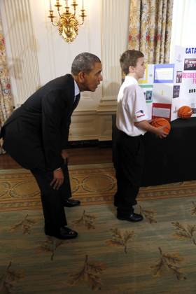 May 27, 2014 - Washington, District Of Columbia, U.S - United States President Barack Obama catches a ball from the Basketball Catapult a science project of Brooke Bohn (unseen), Daisjaughn Bass (unseen) and Gerry McManus (r), from Hudson Massachusetts, winners of the Raytheon and New England Patriots Science of Sports during the 2014 White House Science Fair at the White House, Washington DC, Tuesday May 27, 2014. The Fair celebrates the winners of STEM (science, technology, engineering and math) competitions across the country. Copyright: xAudexGuerrucci Pool Cnpx