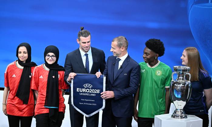 Ireland and United Kingdom confirmed to co-host 2028 UEFA European Football Championship GENEVA, SWITZERLAND - OCTOBER 10: UEFA President Aleksander Ceferin (3rd R) and Welsh retired professional footballer, heading the delegation of UK and Ireland Gareth Bale (3rd L) hold the pennant as they pose with the pennant next to the trophy after United Kingdom and Ireland were elected to host the Euro 2028 football tournament during a ceremony held after the Executive Board meeting at the UEFA headquarters in Nyon, Geneva, Switzerland on October 10, 2023. Geneve Isviçre. Editorial use only. Please get in touch for any other usage. Copyright: x2025xAnadoluxDursunxAydemirx